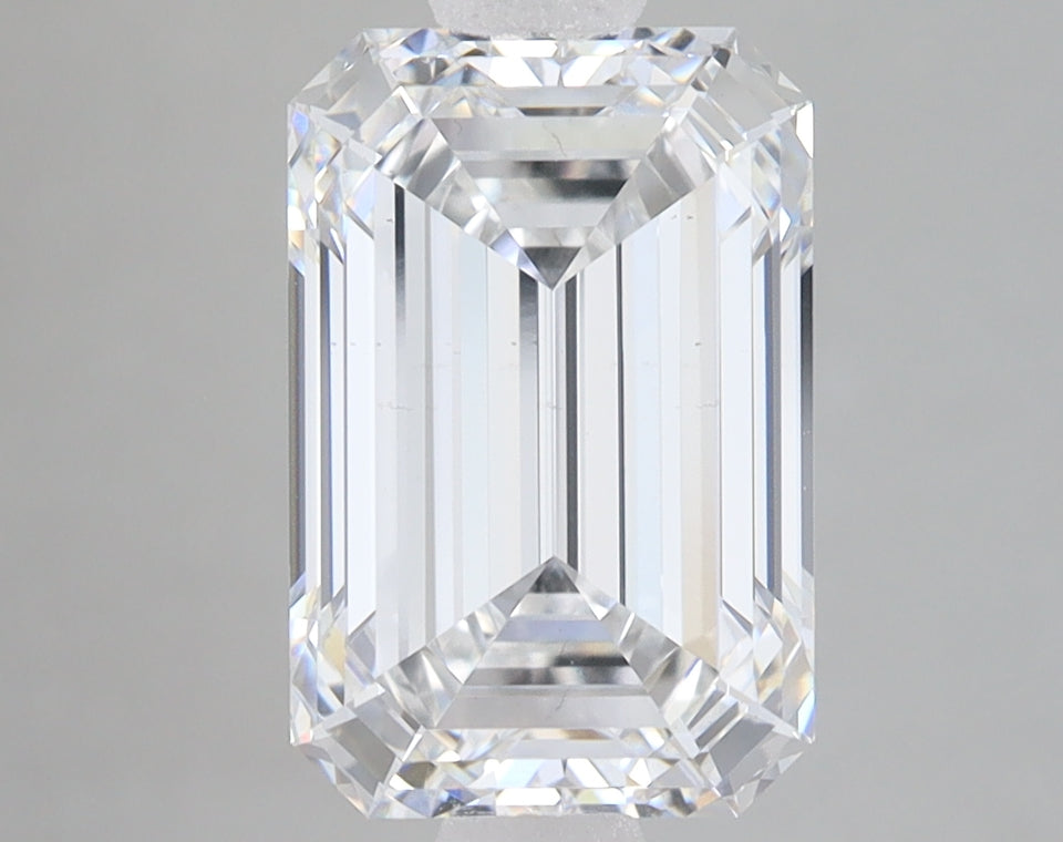 Emerald-cut lab-grown diamond with faceted rectangular shape and clear transparency on gray background.