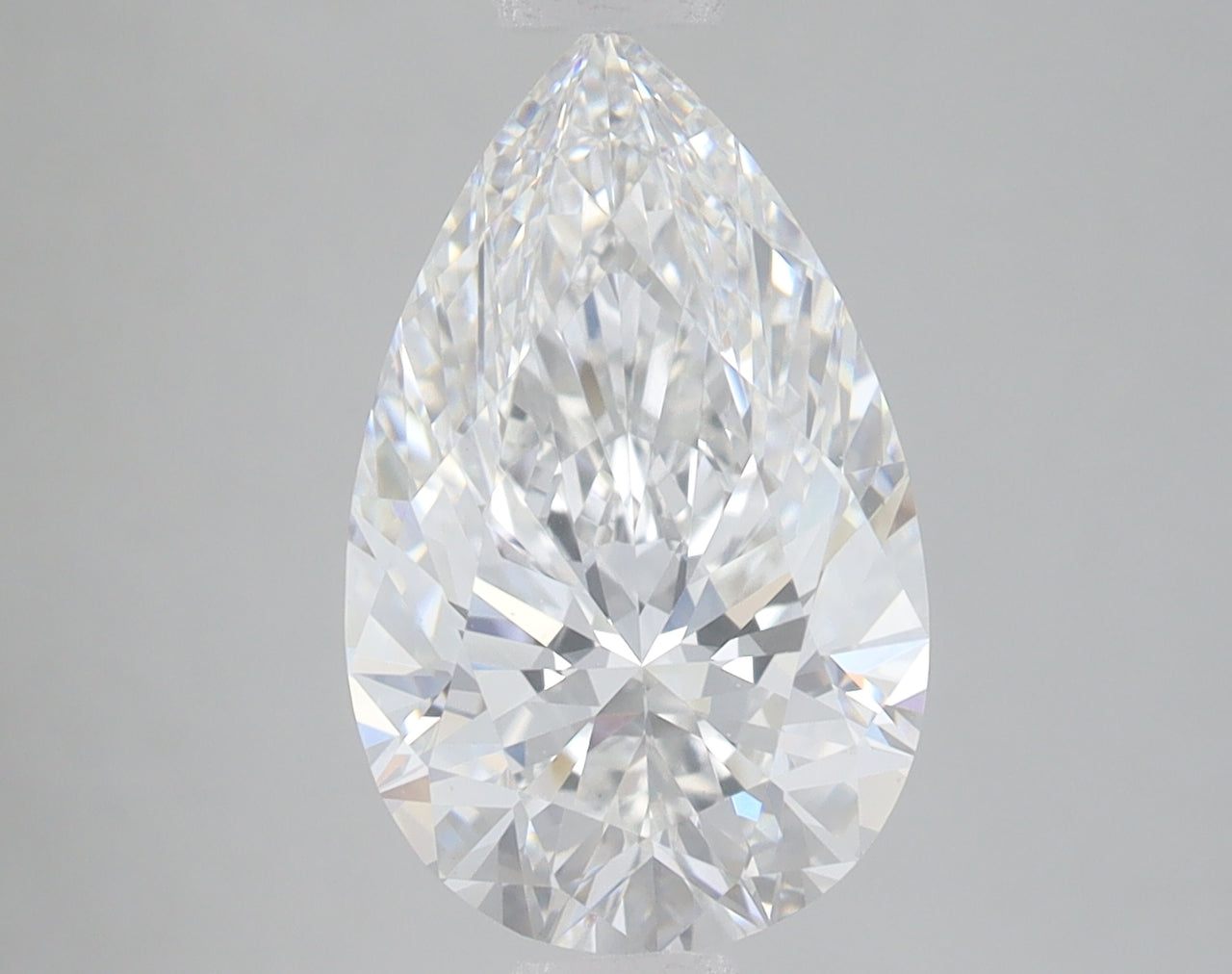 Pear-shaped lab-grown diamond with faceted cuts reflecting light, displayed against neutral gray background.