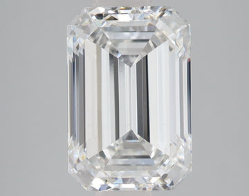 Emerald-cut lab-grown diamond with faceted surfaces and light reflections on gray background.