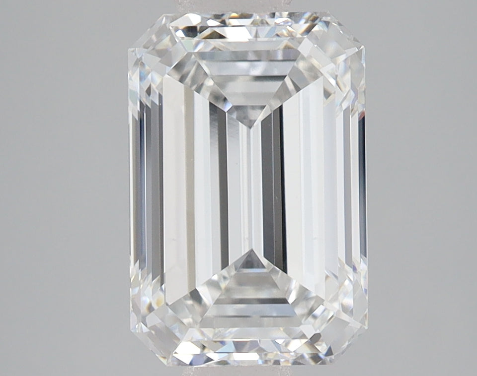Emerald-cut lab-grown diamond with faceted surfaces and light reflections on gray background.