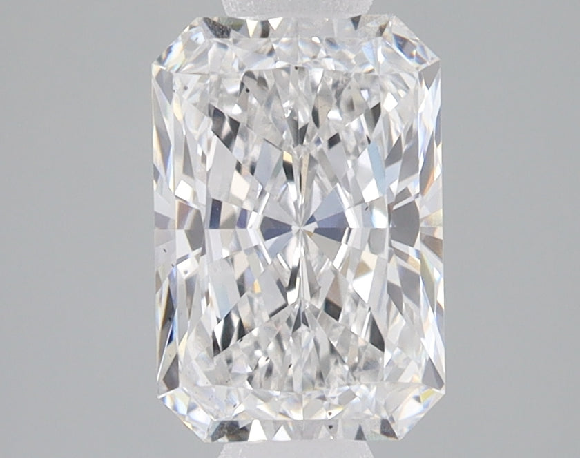 Clear radiant-cut lab-grown diamond with faceted surface and light refraction on gray background.