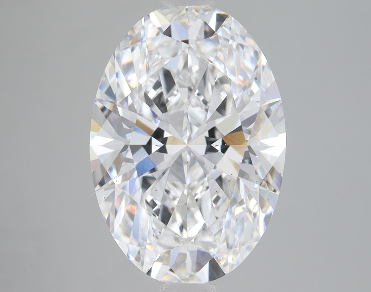 Oval-cut lab-grown diamond with faceted surfaces reflecting light, displayed against a neutral background.