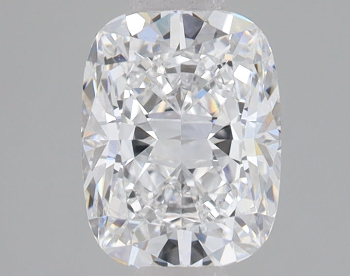 Colorless cushion-cut loose diamond with faceted surface displaying light refraction on neutral background.