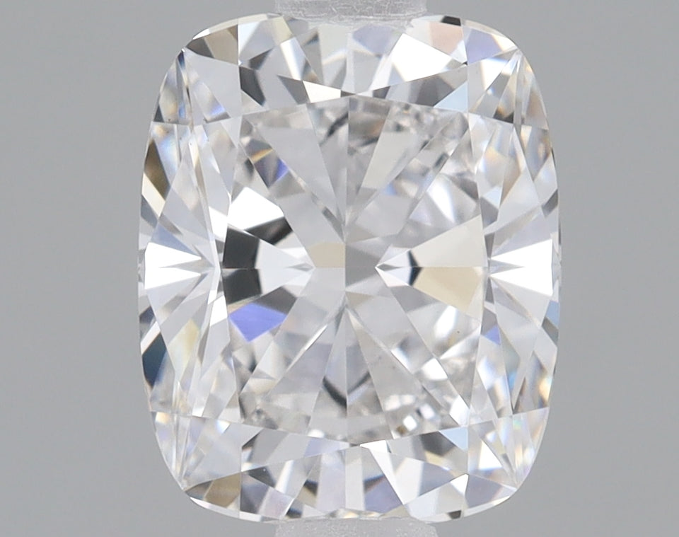 Cushion cut lab-grown diamond with brilliant faceting and light reflections on neutral background.