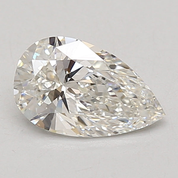Pear-shaped lab-grown diamond with faceted surface and light reflections on neutral background.
