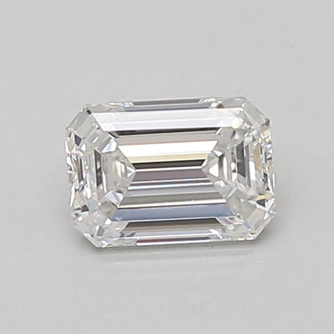 Emerald-cut clear gemstone with faceted surfaces and sharp edges on neutral background.