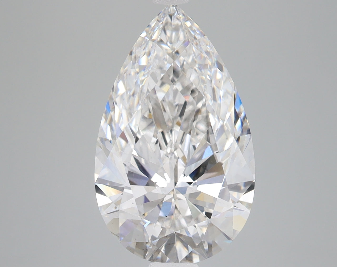 Pear-shaped clear lab-grown diamond with faceted surfaces reflecting light, displayed against a neutral gray background.