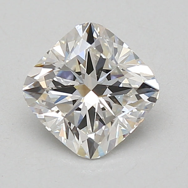 Cushion-cut lab-grown diamond with faceted surfaces and light reflections on neutral background.
