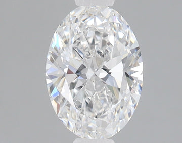 Clear oval-cut diamond with faceted surface reflecting light against gray background.