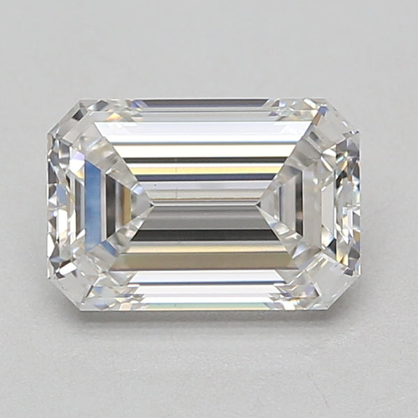 Emerald-cut lab-grown diamond with faceted edges and clear transparency, displayed on gray background.