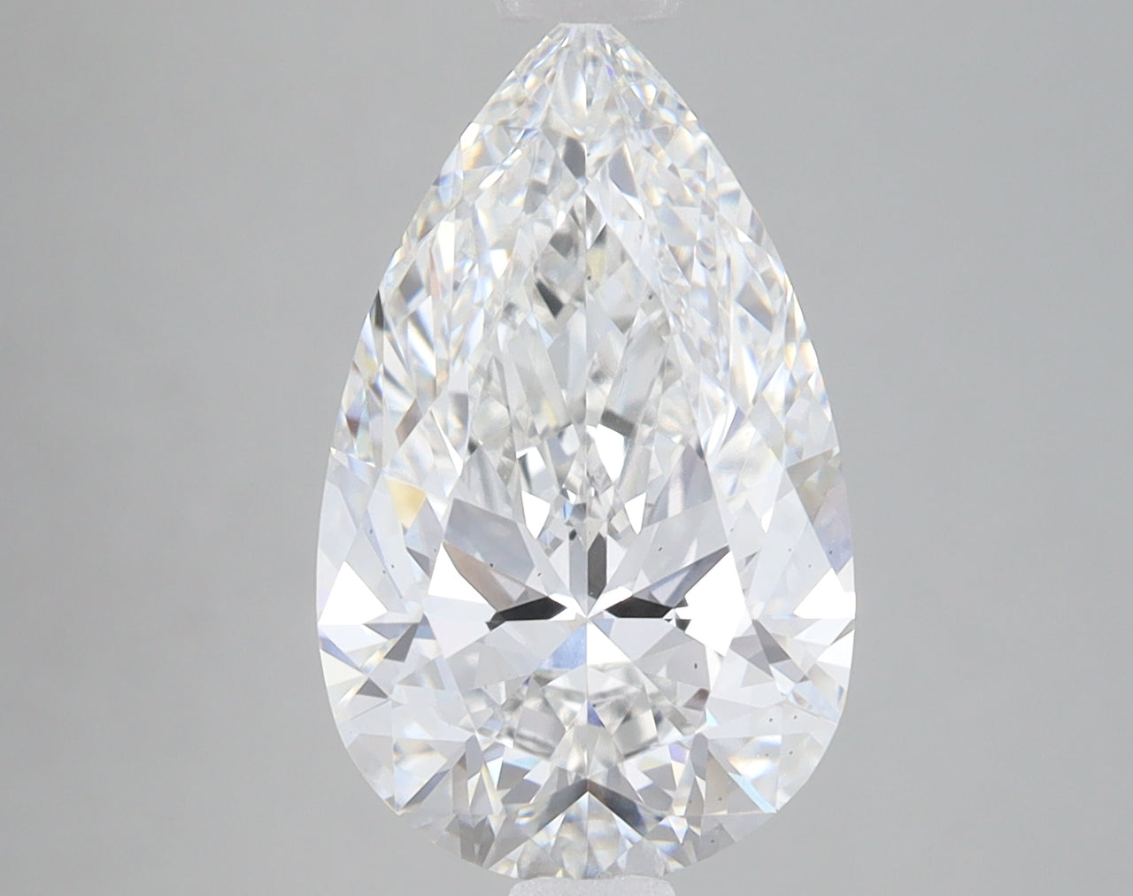 Pear-shaped lab-grown diamond with faceted surface and light reflections displayed against neutral background.