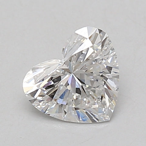 Heart-shaped lab-grown diamond, 0.85 carat, with faceted surface and light reflections on neutral background.