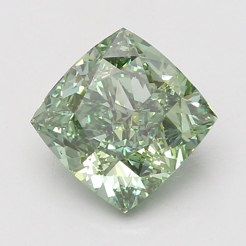 Cushion-cut lab-grown diamond with light green tint and faceted surface, displayed against neutral background.