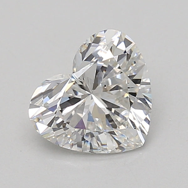 Heart-shaped lab-grown diamond loose stone with faceted surface, displaying light reflections.
