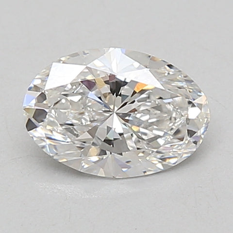 Oval-cut lab-grown diamond with faceted surface and light reflections on neutral background.