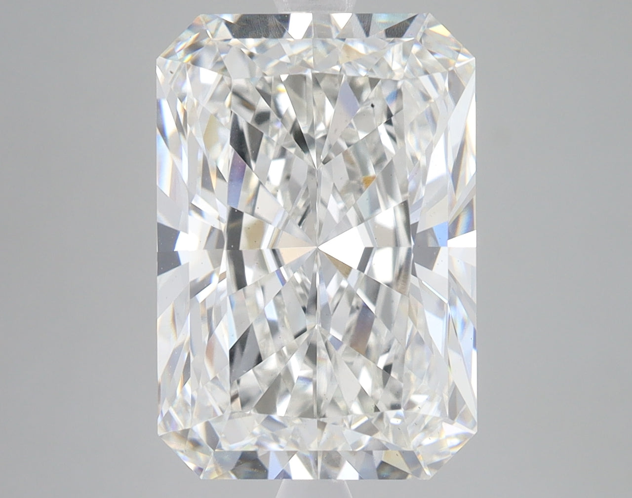 Radiant cut lab grown diamond with faceted surfaces reflecting light, displaying clear colorless appearance against neutral b
