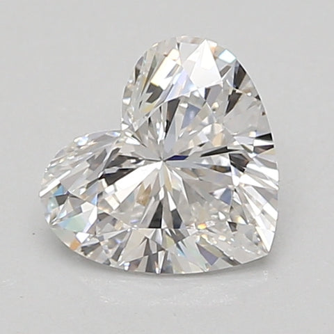 Heart-shaped faceted lab-grown diamond with clear faceting and light reflections against a neutral background.