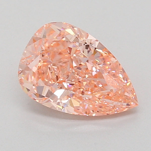 Pear-shaped lab-grown diamond with faceted surface and light peachy-pink coloring on neutral background.