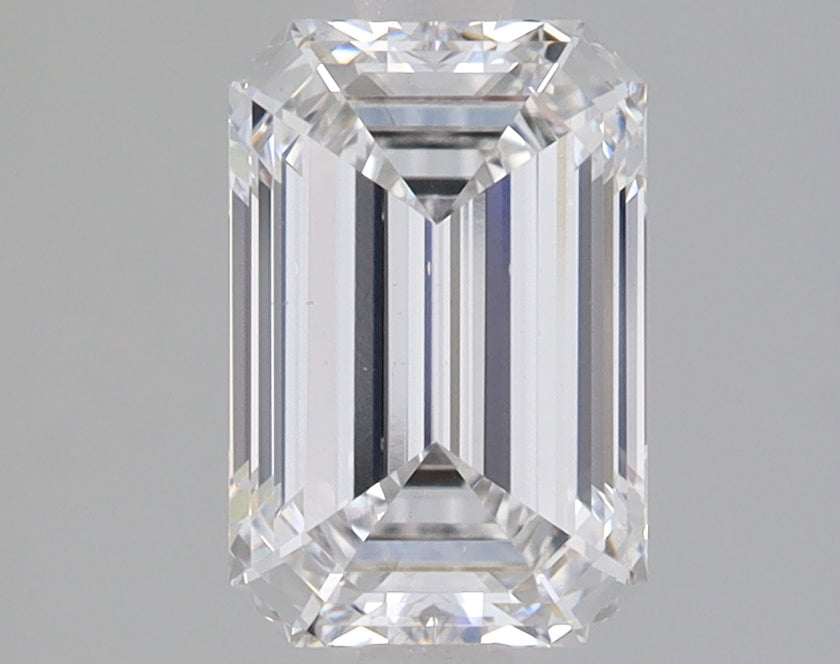 Emerald-cut lab-grown diamond loose stone with faceted surfaces and clear transparency displayed against gray background.