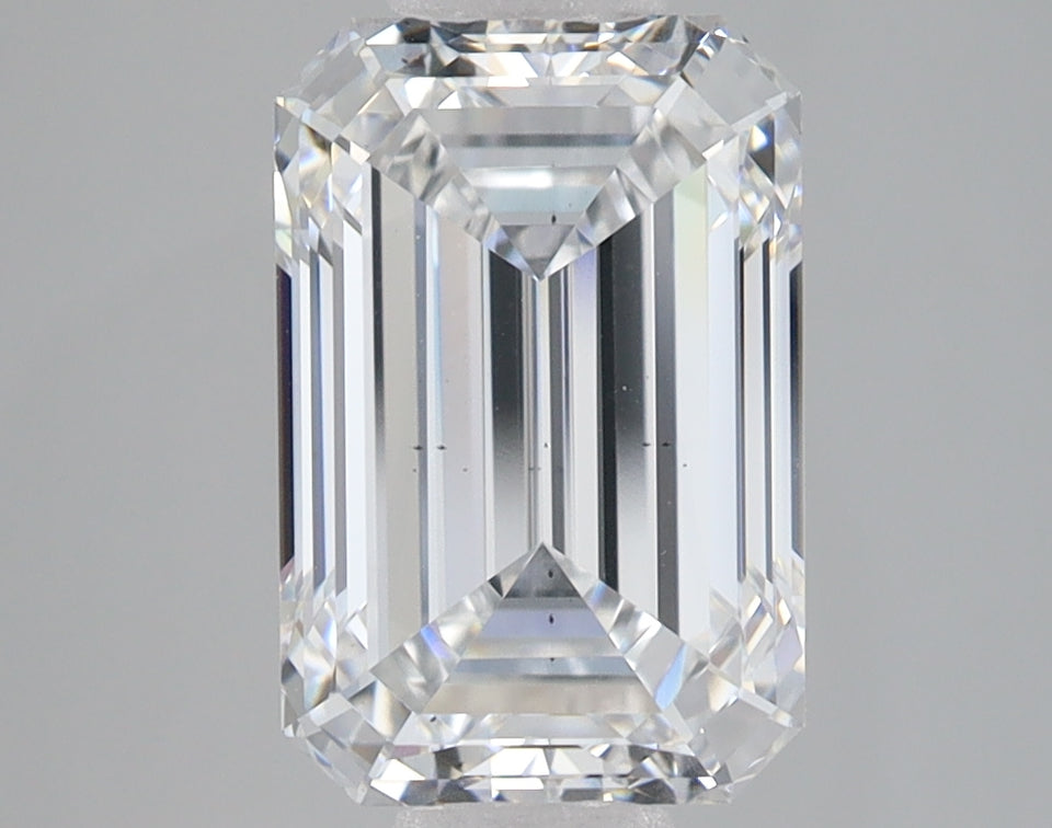 Emerald-cut lab-grown diamond with faceted surfaces and clear transparency on gray background.