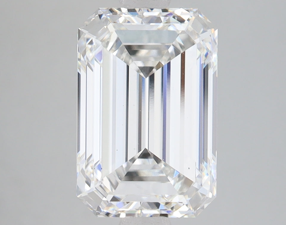 Colorless emerald-cut lab-grown diamond with faceted edges and light refraction visible against neutral background.