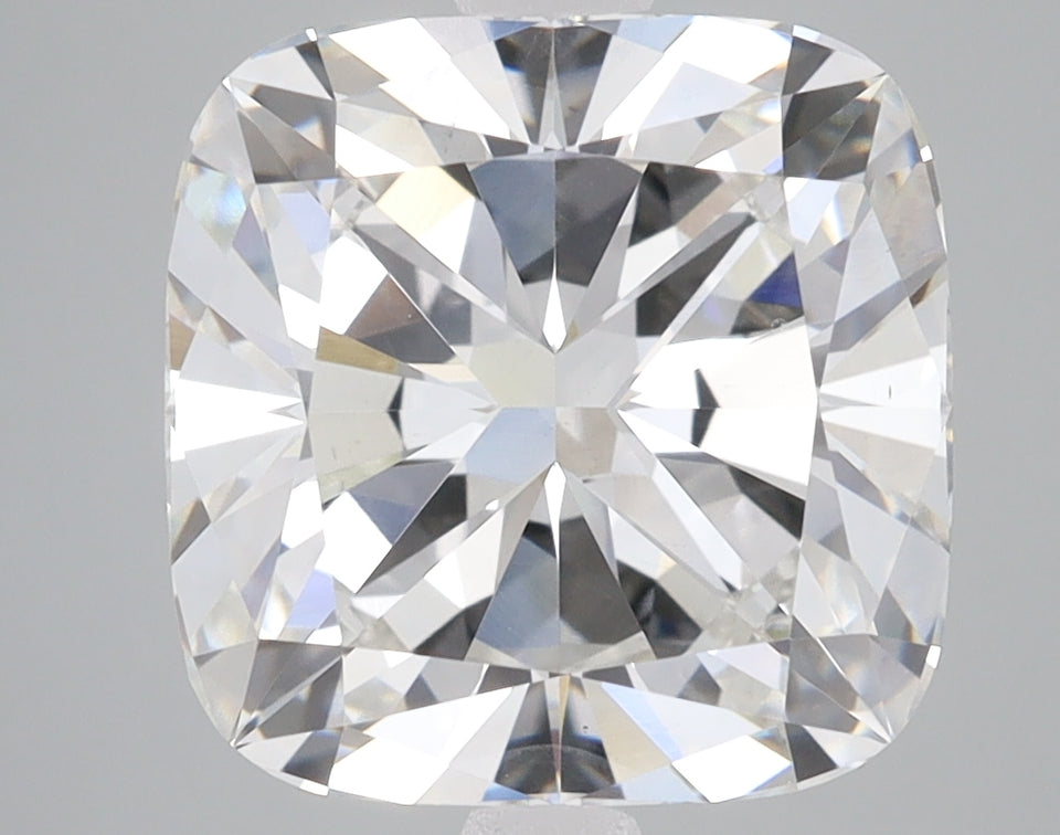 Colorless cushion cut loose diamond with faceted surface reflecting light, displayed against neutral background.