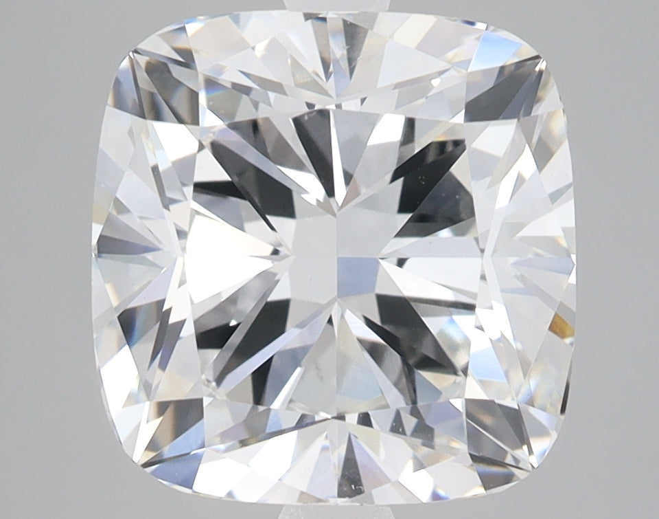Cushion-cut lab-grown diamond with faceted surfaces reflecting light, displayed against a neutral gray background.