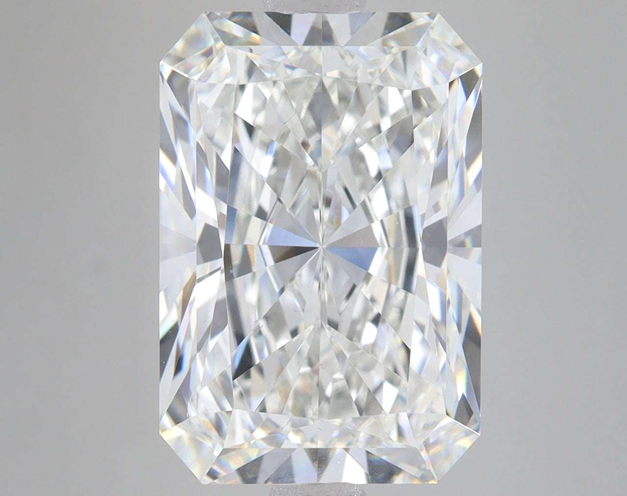 Radiant cut lab-grown diamond with faceted surfaces and clear brilliance on neutral gray background.