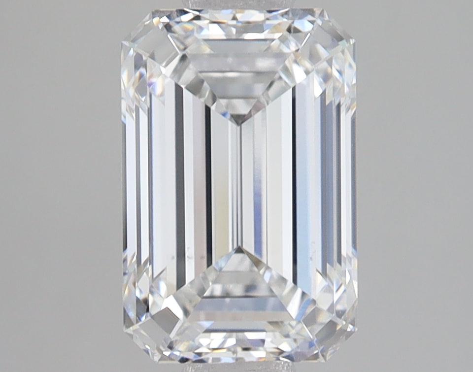 Emerald-cut diamond with faceted rectangular shape and stepped edges, displaying light refraction on neutral background.