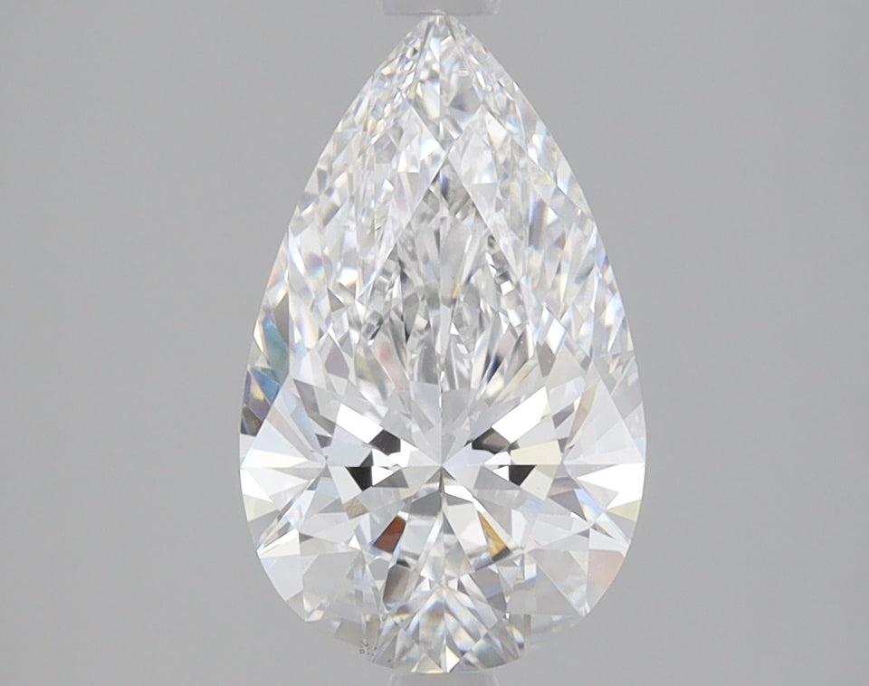 Clear pear-shaped diamond with faceted surface and bright light refraction on neutral gray background.