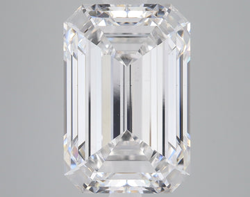 Clear emerald-cut lab-grown diamond with faceted edges displaying light refraction on gray background.