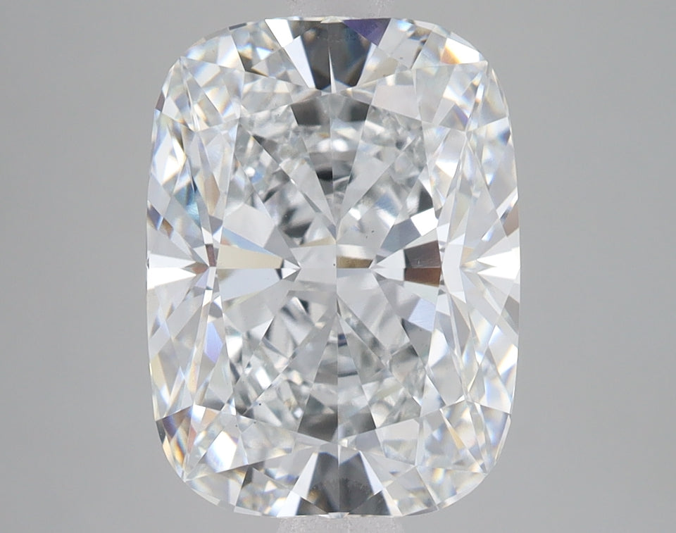 Cushion-cut lab-grown diamond with faceted surfaces reflecting light, displayed against neutral gray background.