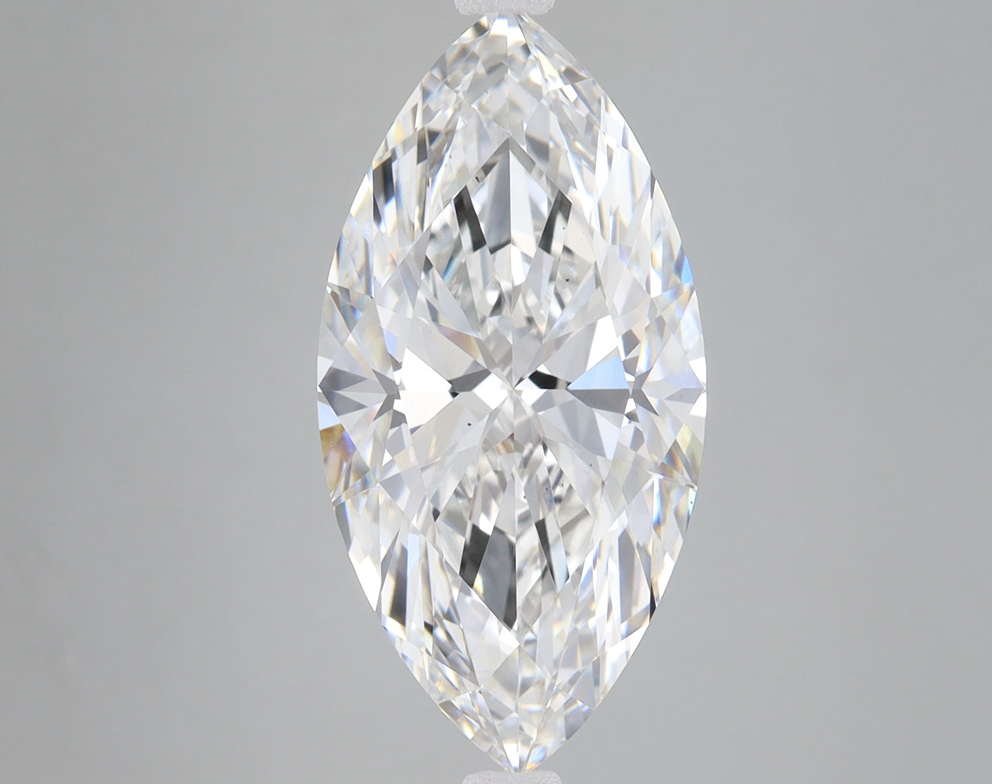 Marquise-cut colorless diamond with faceted surface and brilliant light reflection against neutral background.