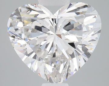 Heart-shaped lab-grown diamond with brilliant faceting and light reflections on gray background.