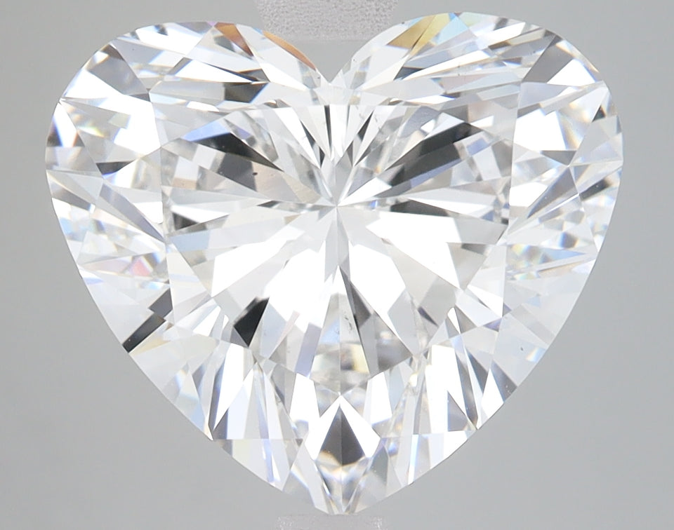 Heart-shaped lab-grown diamond with brilliant faceted cut and light refraction on neutral background.