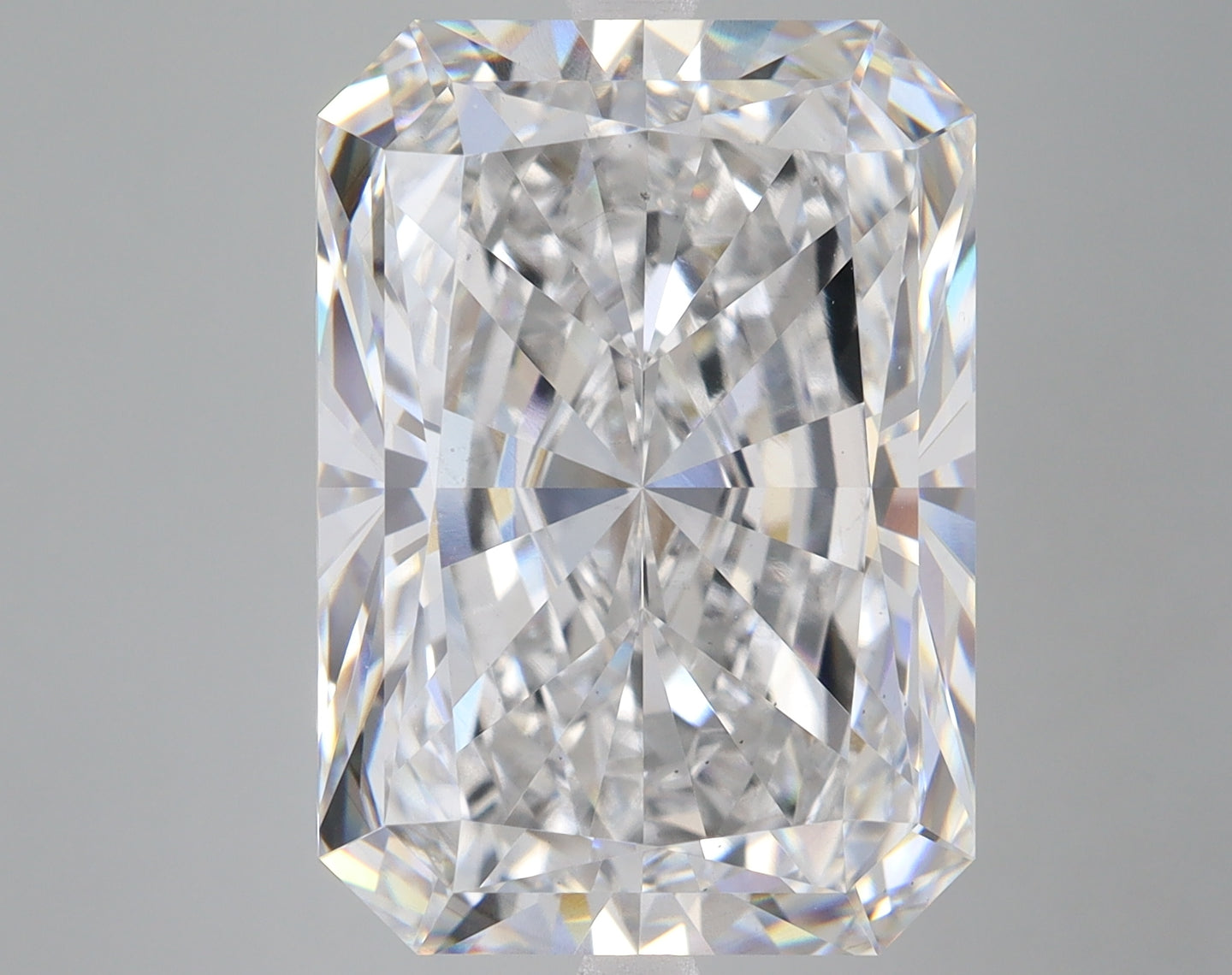Radiant cut lab grown diamond with clear faceted surface and light refraction on neutral background.