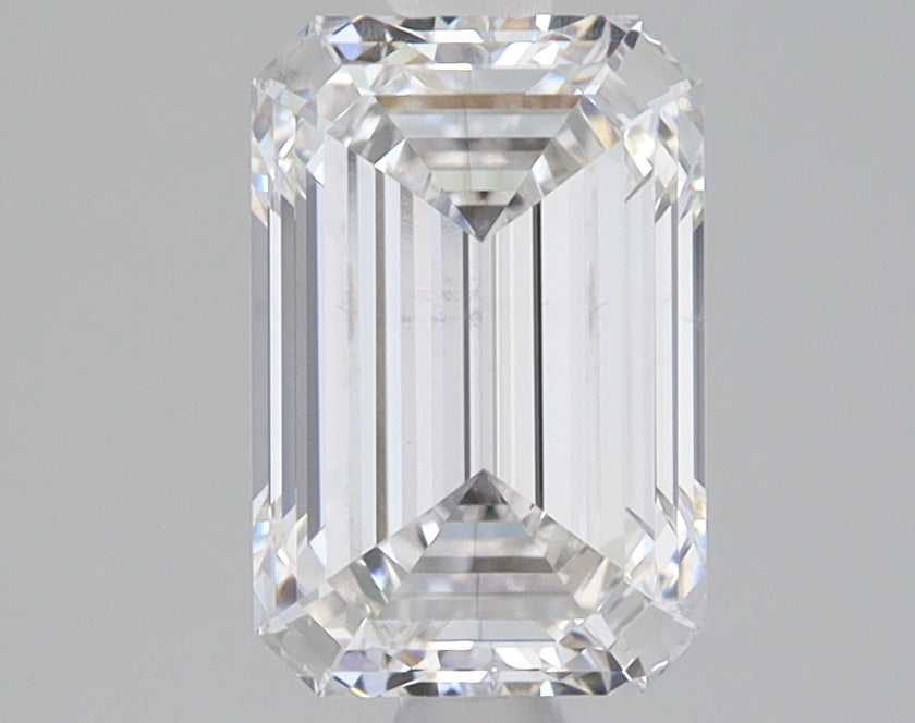 Emerald-cut lab-grown diamond with faceted surfaces and clear transparency, displayed against neutral background.