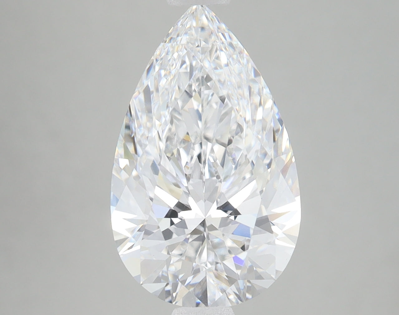 Pear-shaped colorless lab-grown diamond with faceted surface and brilliant light refraction on neutral background.