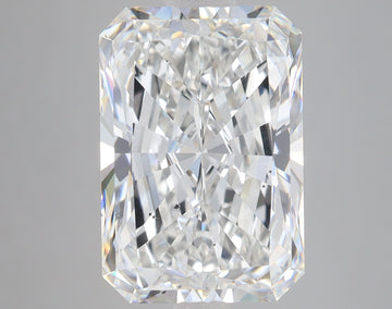 Radiant cut loose diamond with faceted surface and bright light reflections on neutral background.