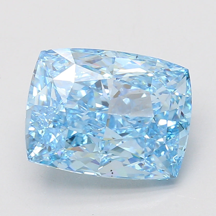 Light blue cushion-cut diamond with faceted surfaces and light reflections on neutral background.