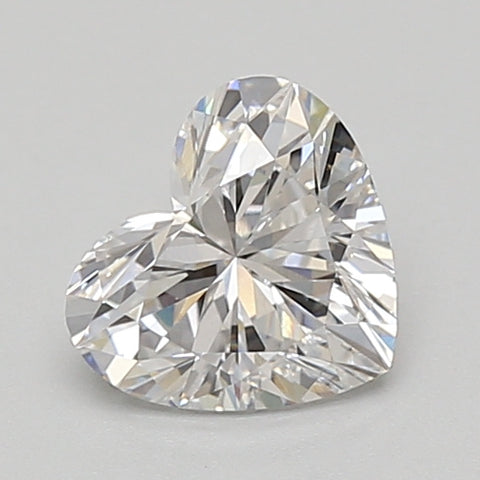 Heart-shaped lab-grown diamond with faceted cut and bright light reflections on neutral background.