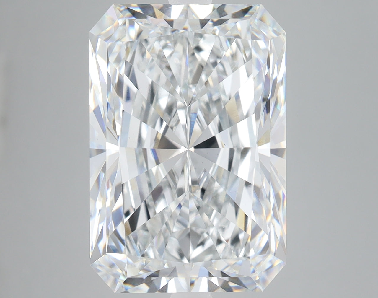 Clear radiant-cut lab-grown diamond with faceted surfaces reflecting light, displayed against neutral background.