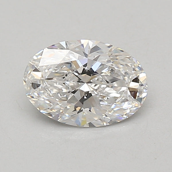 Oval-cut lab-grown diamond with faceted surface reflecting light, displayed on neutral background.