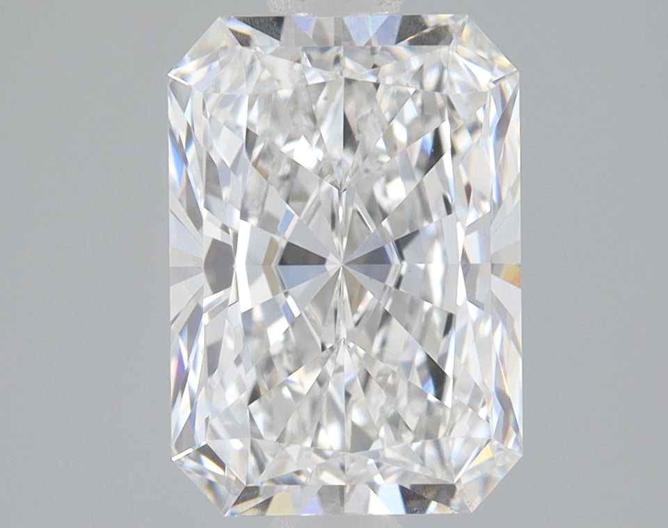 Radiant cut diamond with clear faceting and light reflections on neutral background.