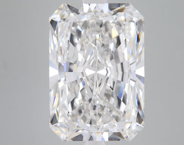 Radiant cut loose diamond with faceted surface and light reflections on gray background.
