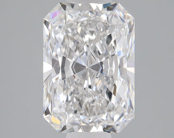 Radiant cut loose diamond with faceted surfaces and light refraction, displayed on neutral gray background.