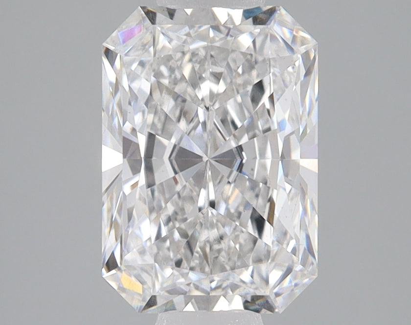 Radiant cut loose diamond with faceted surfaces and light refraction, displayed on neutral gray background.