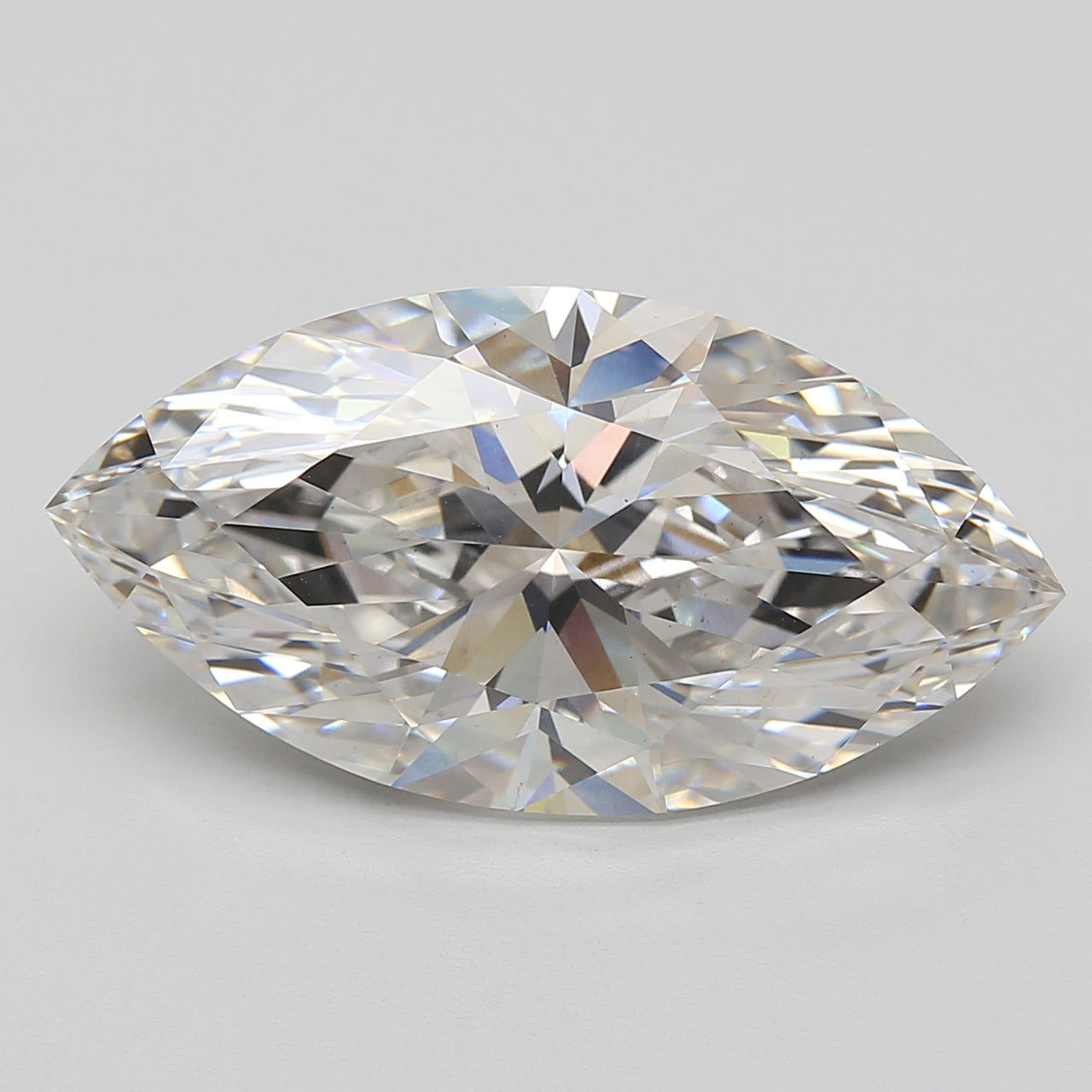 Marquise-cut lab-grown diamond with faceted surface reflecting light, displayed against neutral gray background.