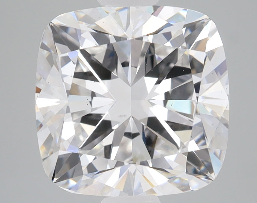 Cushion cut lab grown diamond with faceted surface displaying light refraction and sparkle against neutral background.