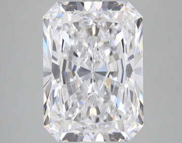 Radiant cut lab grown diamond with faceted surfaces reflecting light, displayed against neutral gray background.